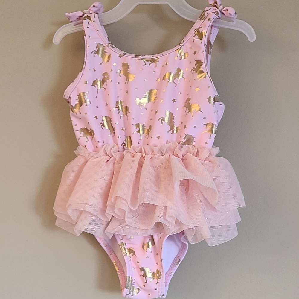 Nicole Miller light pink one piece swimsuit with gold unicorn print